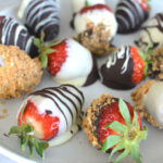 close-up view of a circular plate adorned with a delicious assortment of chocolate-coated strawberries