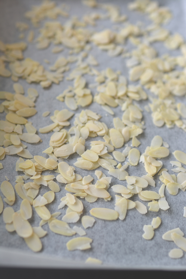 close up image of flaked almonds in a baking tray