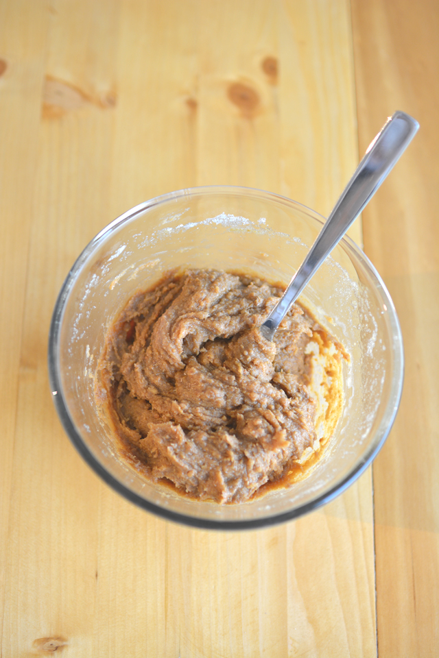 top-down view of a bowl filled with batter for peanut butter, chocolate and pistachio cookies