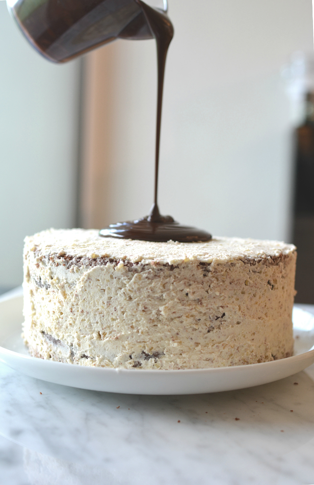 an image of ganache being poured over a cake spread with buttercream