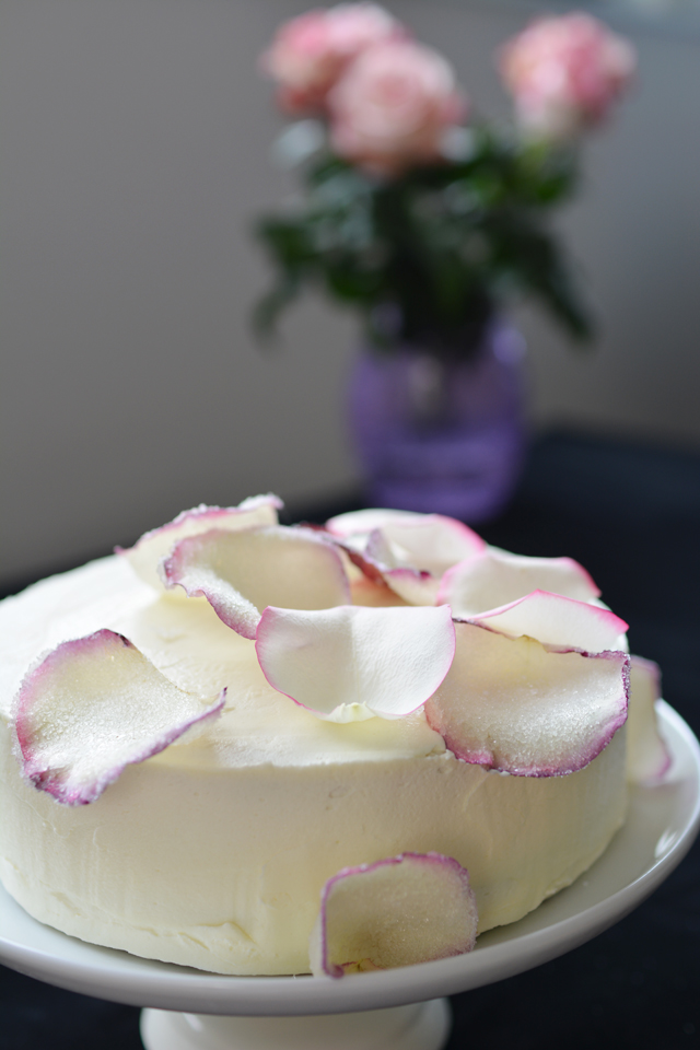 A side view of cake with petals.