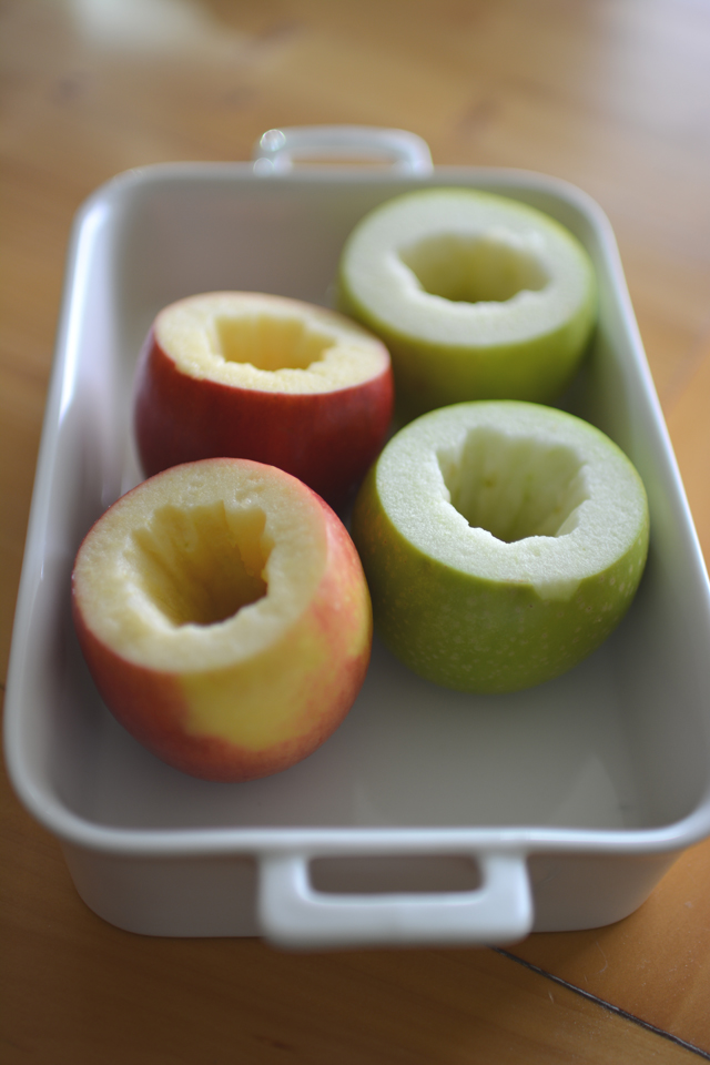 close-up of four fresh apples, two red and two green, with the tops cored and scooped out