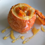 close-up view of a freshly baked dinner cheese and apple drizzled with honey