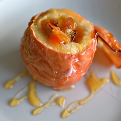 close-up view of a freshly baked dinner cheese and apple drizzled with honey