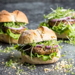 Super quick vegan black bean burgers. Ready in 15-20 minutes, these are packed with protein and fresh veggies, perfect for a late summer picnic!