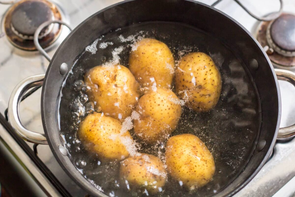 Potatoes boiling in a large pot.