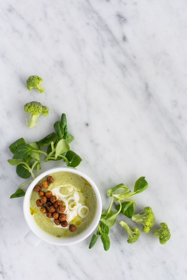 top view image of a bowl filled with broccoli and quinoa soup topped with roasted chickpeas