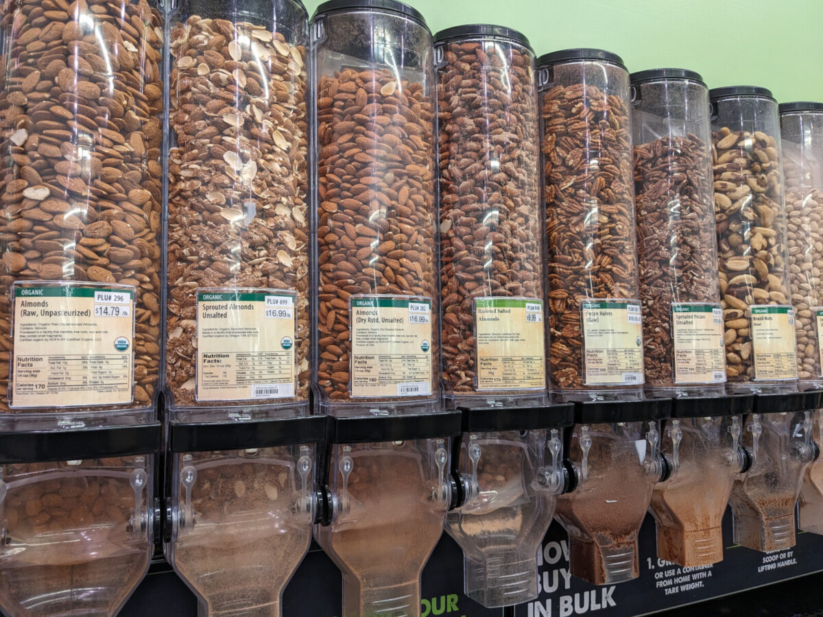 Various nuts in the bulk food section at the grocery store.