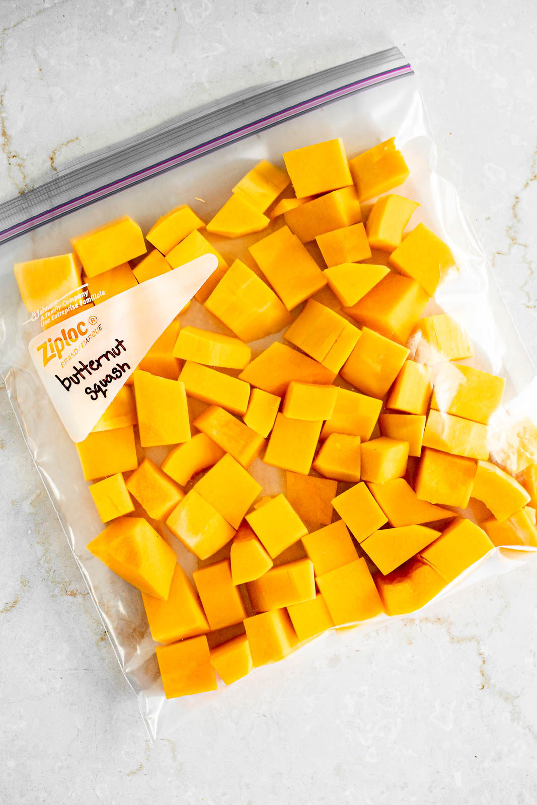 Cubes of butternut squash cut up in a freezer bag.