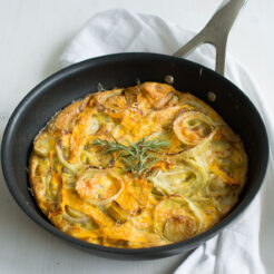 cropped image of a freshly baked Butternut Squash Frittata in a wok, topped with fragrant rosemary