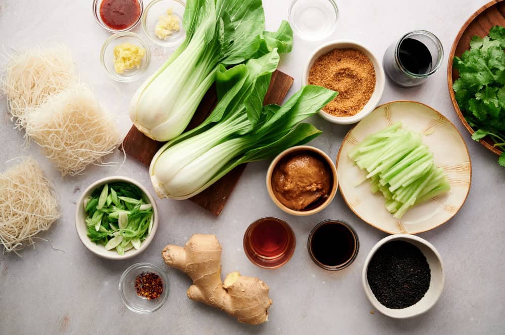 Ingredients for Cold Asian Noodle Salad arranged on a marble countertop.