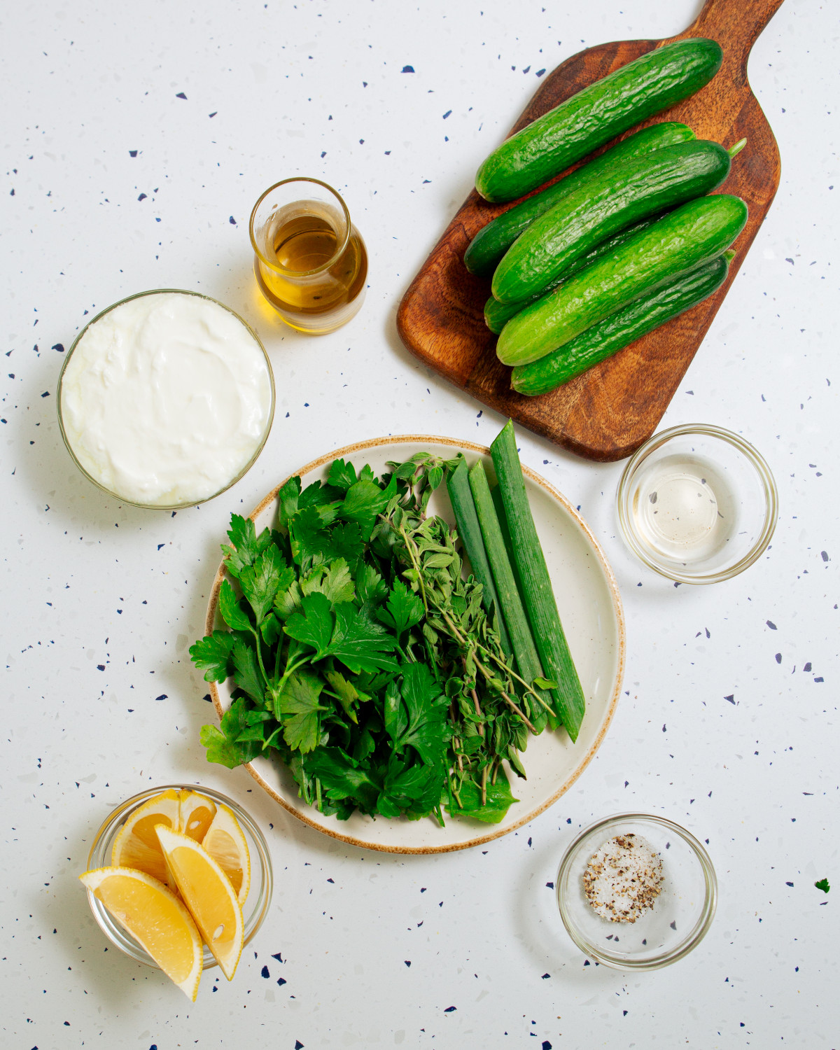 Ingredients for cold cucumber soup laid out on a countertop.