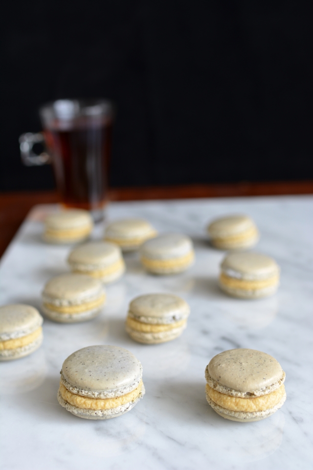 image of a colorful assortment of macarons filled with rich ganache, elegantly displayed on a table