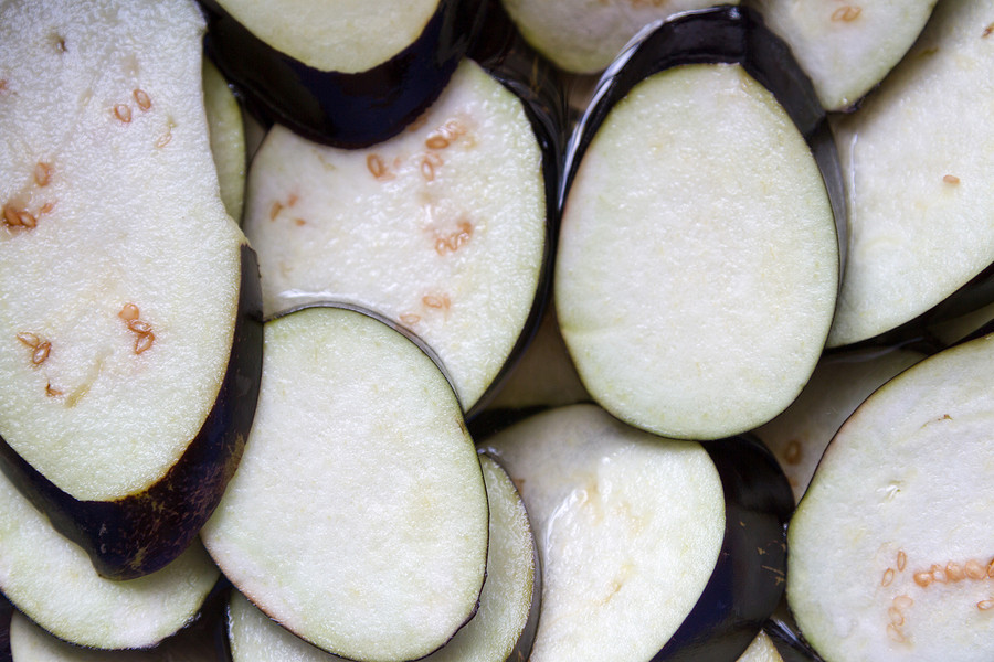 Eggplant slices soaking in water.