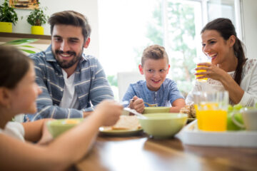 A family eating breakfast together at a table.