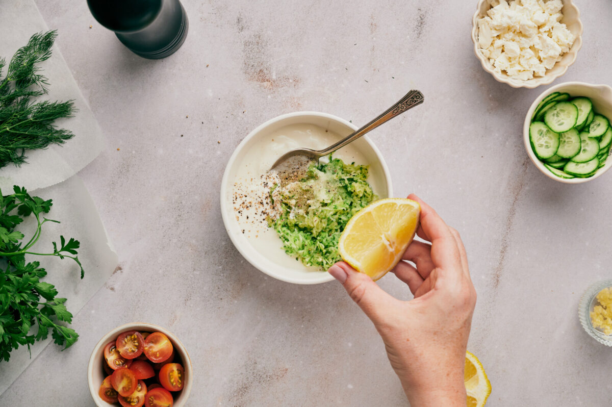 Mixing ingredients in a bowl for Tzatziki.