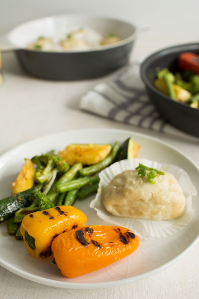 Side View of Green Stir Fry with Two Ingredient Steamed Coconut Buns in a plate