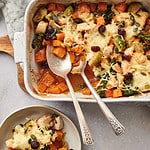 Harvest Chicken Casserole being served with two spoons into a shallow dish.