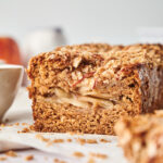 A loaf of healthy apple bread, sliced down the middle.