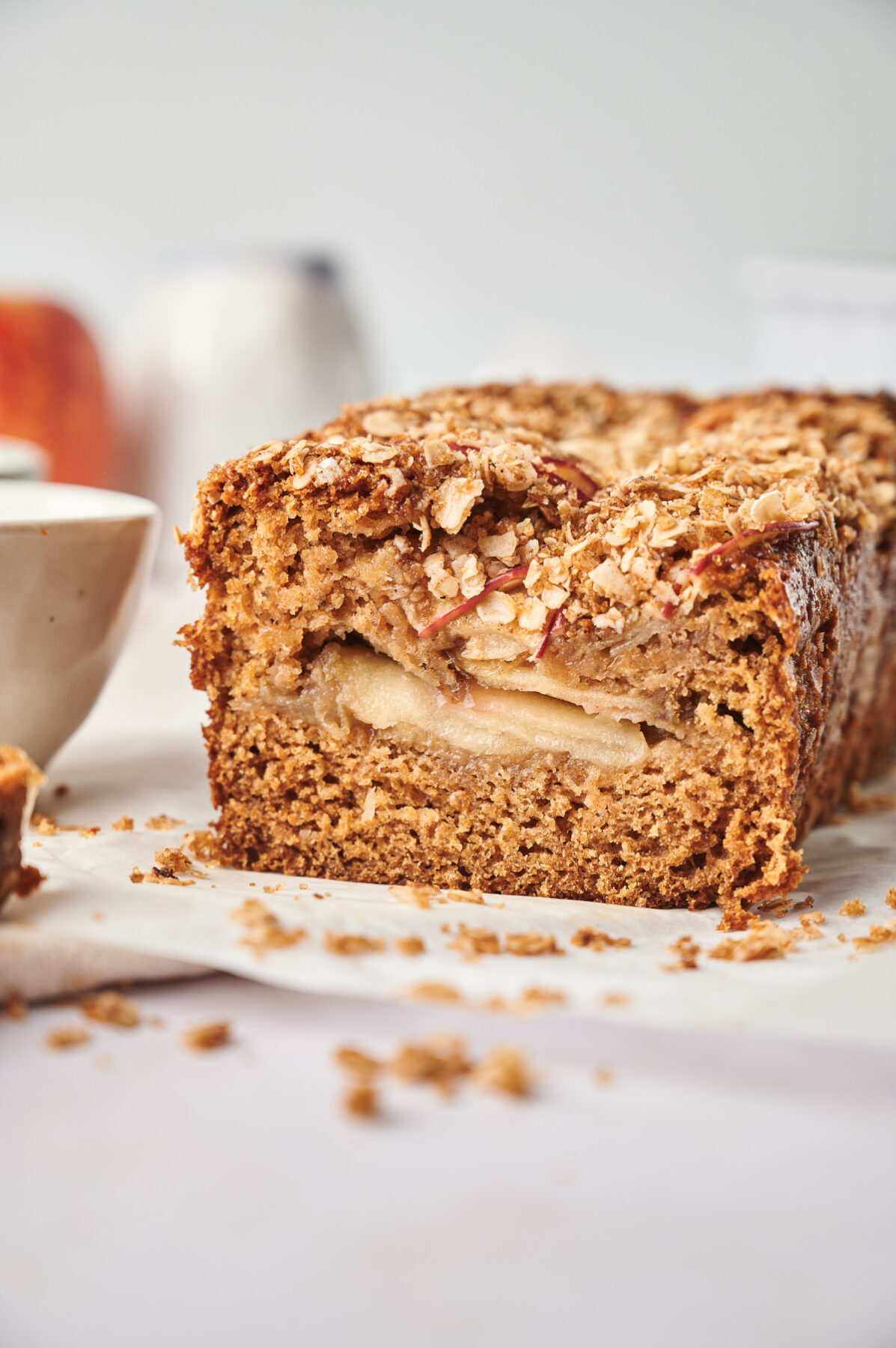 Side view of healthy apple bread with whole apple slices in the middle.