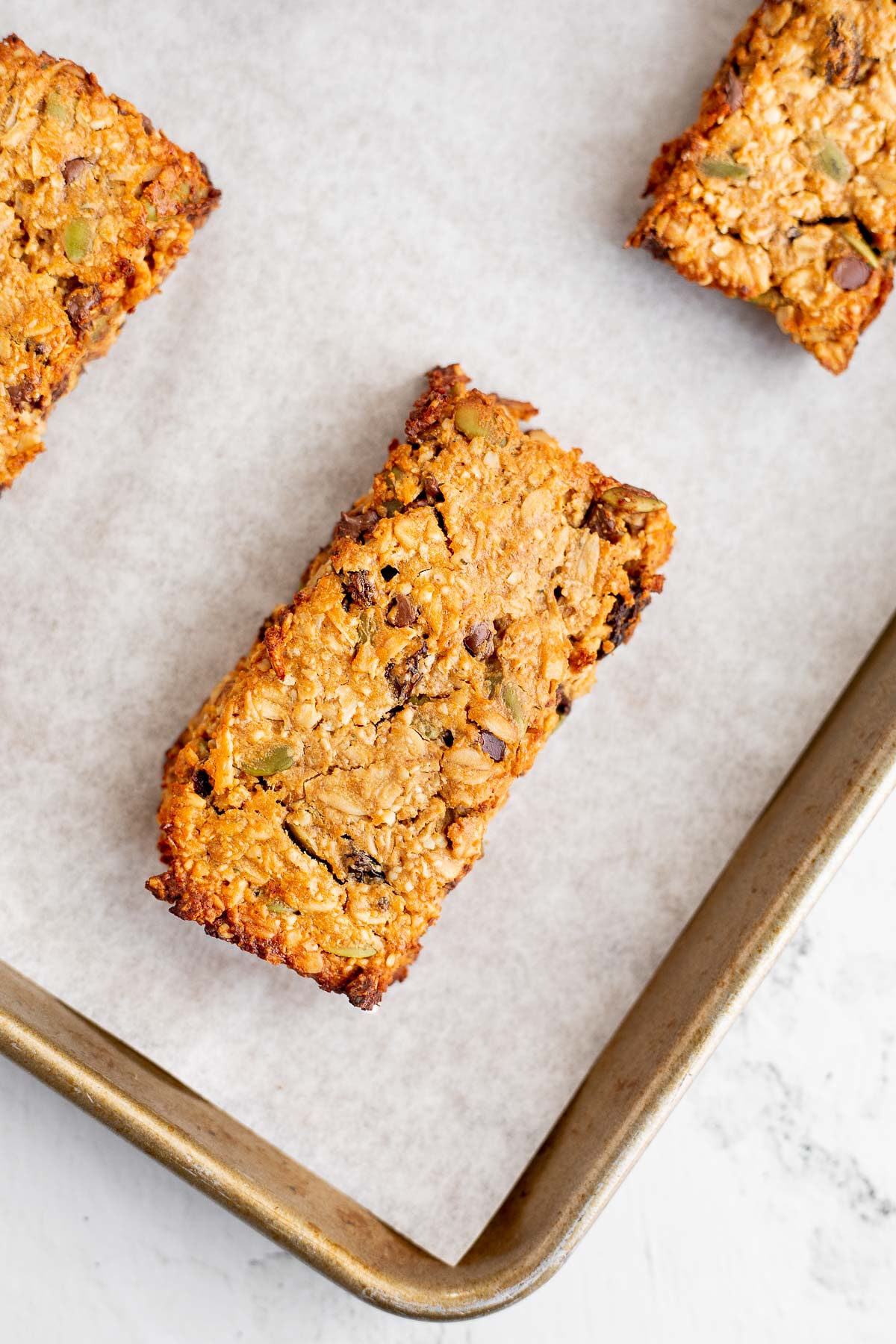 Homemade protein bars on a baking sheet with parchment paper.