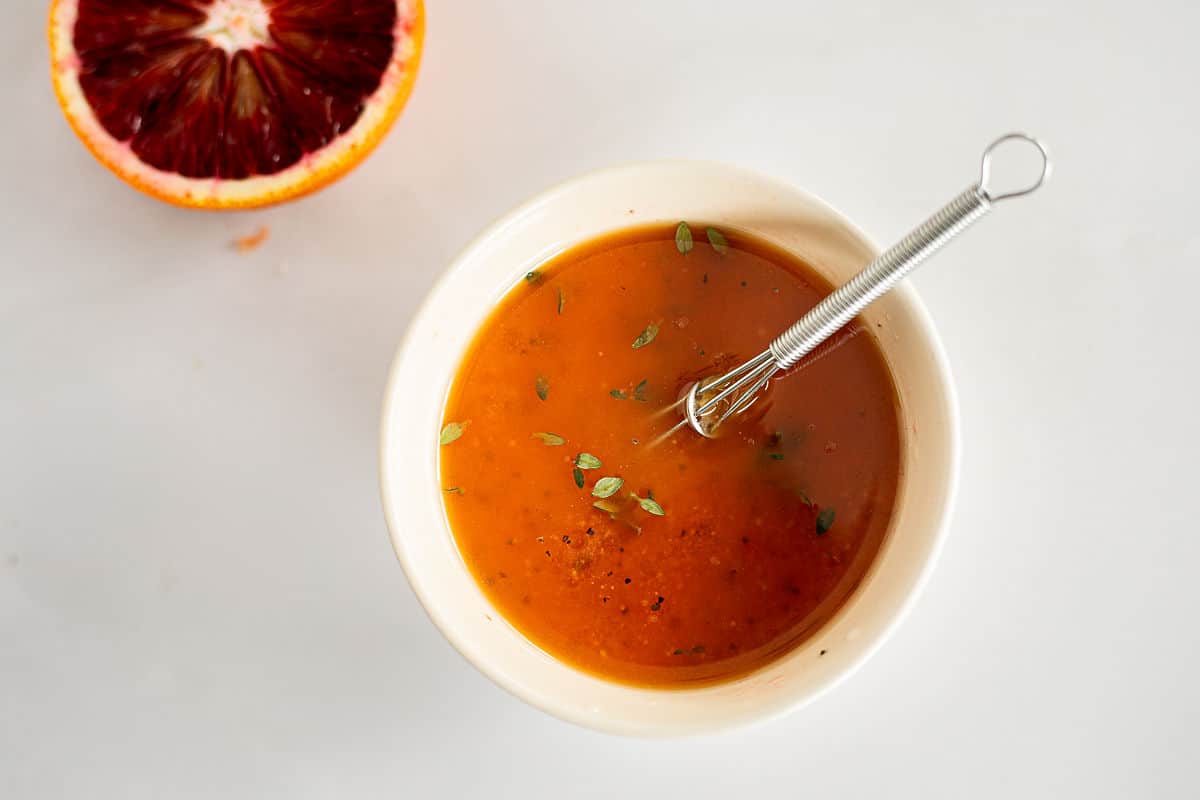 Whisking ingredients for a Honey Citrus Vinaigrette.