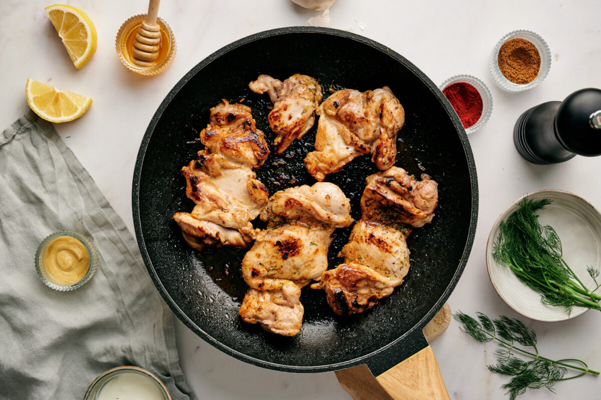 Grilled chicken in a black skillet.