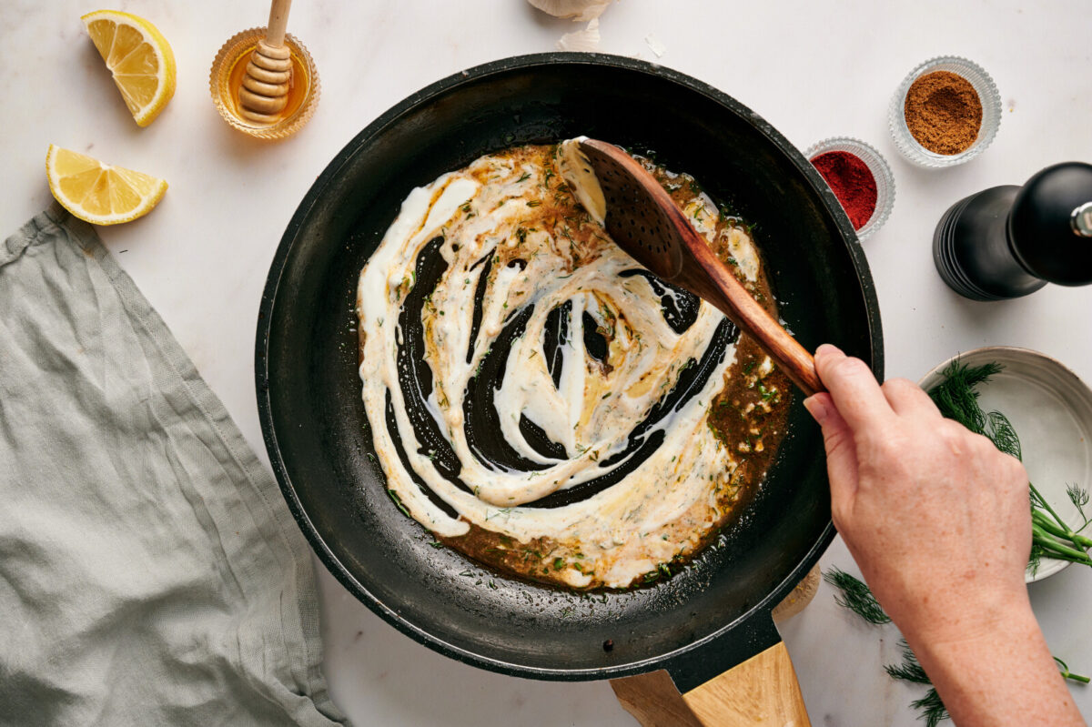 Dijon yogurt sauce in a skillet.