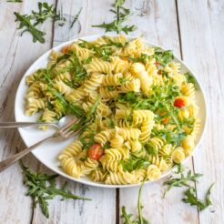 A Lemon Rocket Pasta Salad full of freshness and green goodness. The large fusilli pasta is tossed in fresh lemon juice and just a little olive oil to create this bright, vibrant salad, perfect for a cold lunch on a hot day!