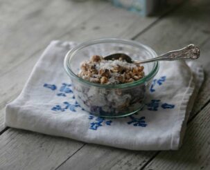 A bowl of oatmeal with a napkin under it.