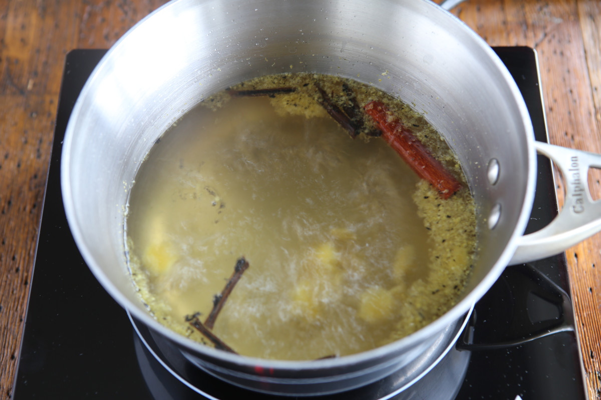 Simmering a simple syrup with infused vanilla, lemon zest, and a cinnamon stick.