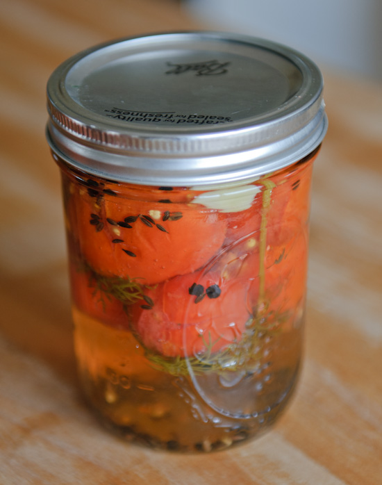 close up of pickled cherry tomatoes in a ball jar