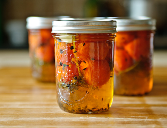 sweet pickled tomatoes in glass jars