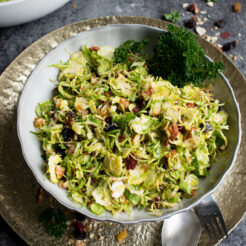 Raw Brussels Sprouts Salad with Dried Fruit served in a baked avocado!