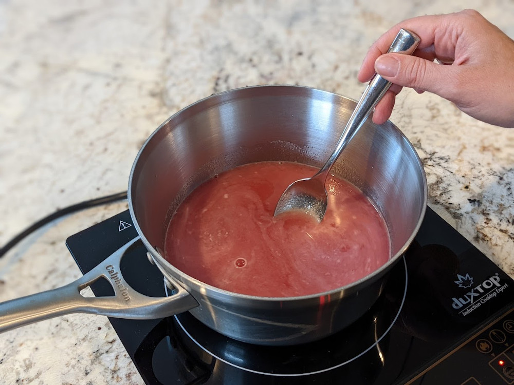 Boiling redbud tea with sugar to make jelly.