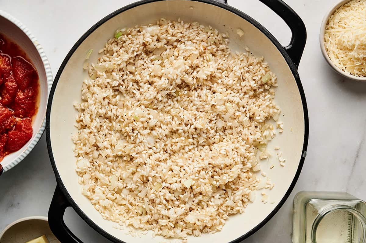 Rice added to the onion and oil and tossed until completely coated.