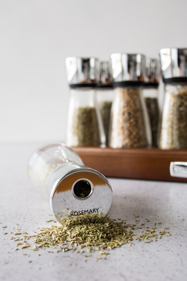 An image of finely chopped dried rosemary stored in a canister.