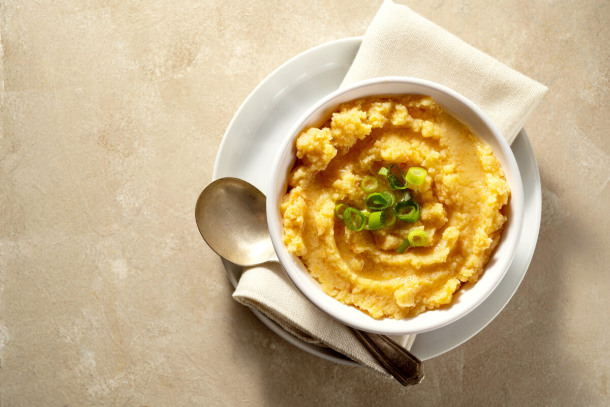 Root mash. Root vegetables mashed in a bowl. Garnished with oil and herbs.