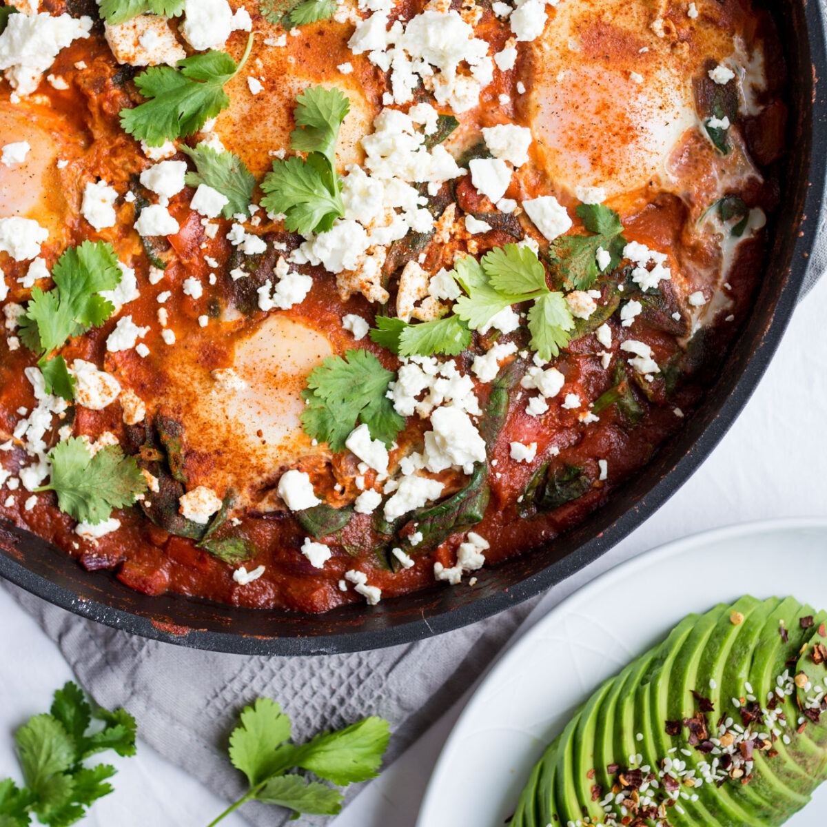 Shakshuka with Spinach is a delicious one skillet breakfast that is ready in under 30 minutes! Full of veggies and protein, this easy, quick breakfast recipe will fill you up for a great day!