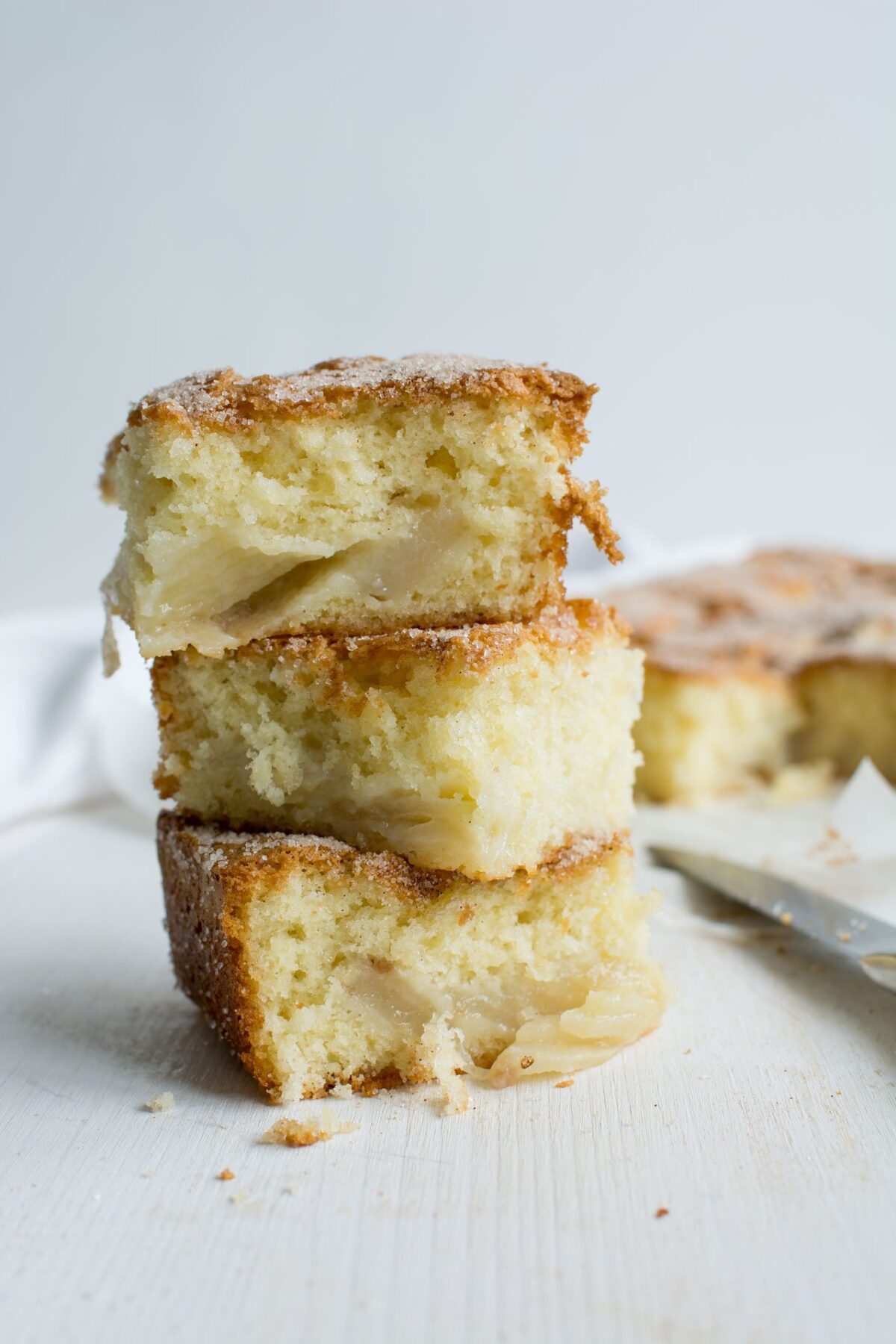 close-up view of three stacked slices of cinnamon spiced pear cake
