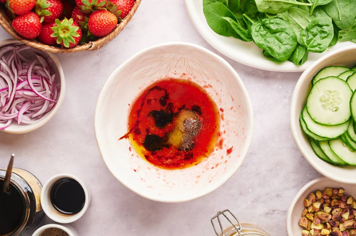 Ingredients for Strawberry Vinaigrette combined in a white bowl.