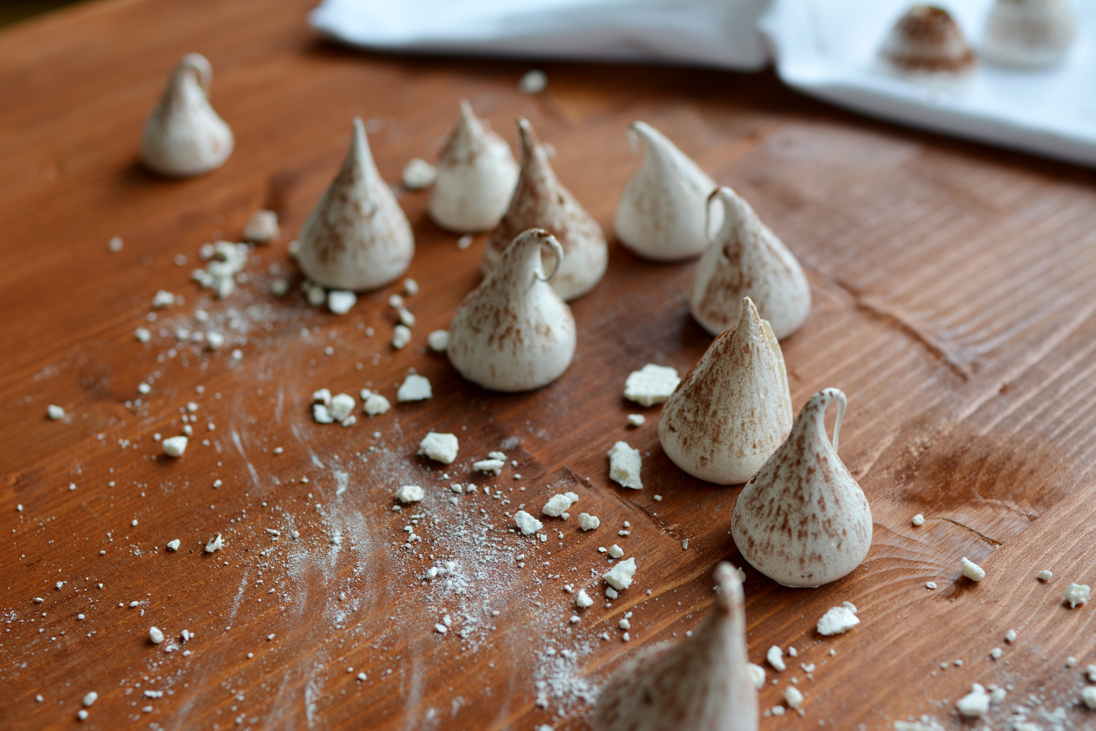 an assortment of swiss meringue kisses scattered on a table