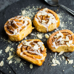 Four Vegan Sweet Potato Cinnamon Rolls with icing.